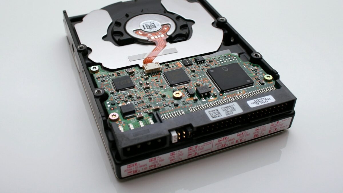 A solid state drive beside a laptop