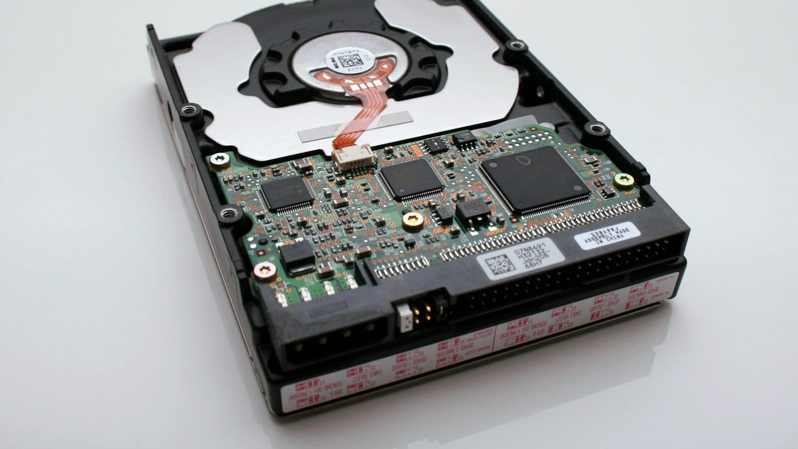 A solid state drive beside a laptop