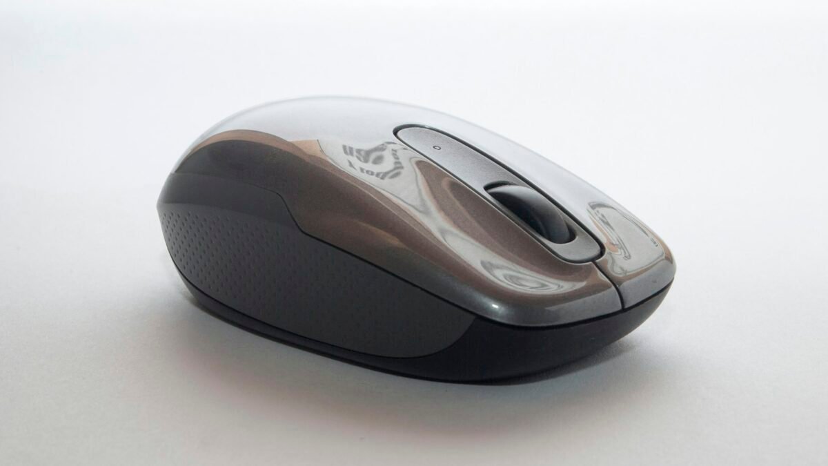 A wireless computer mouse on a desk mat