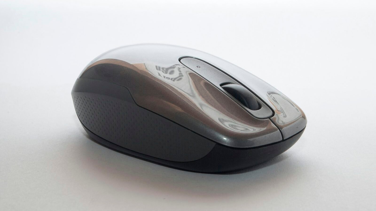 A wireless computer mouse on a desk mat